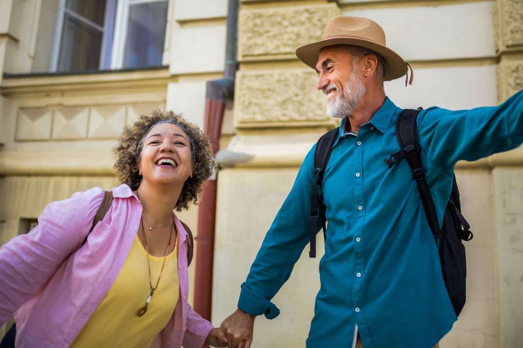 Two adults walking outdoors and laughing together