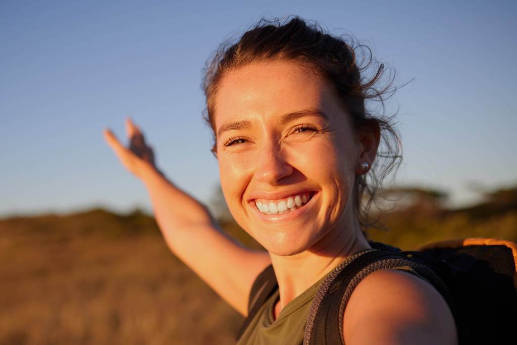 Woman smiling outdoors during a hike